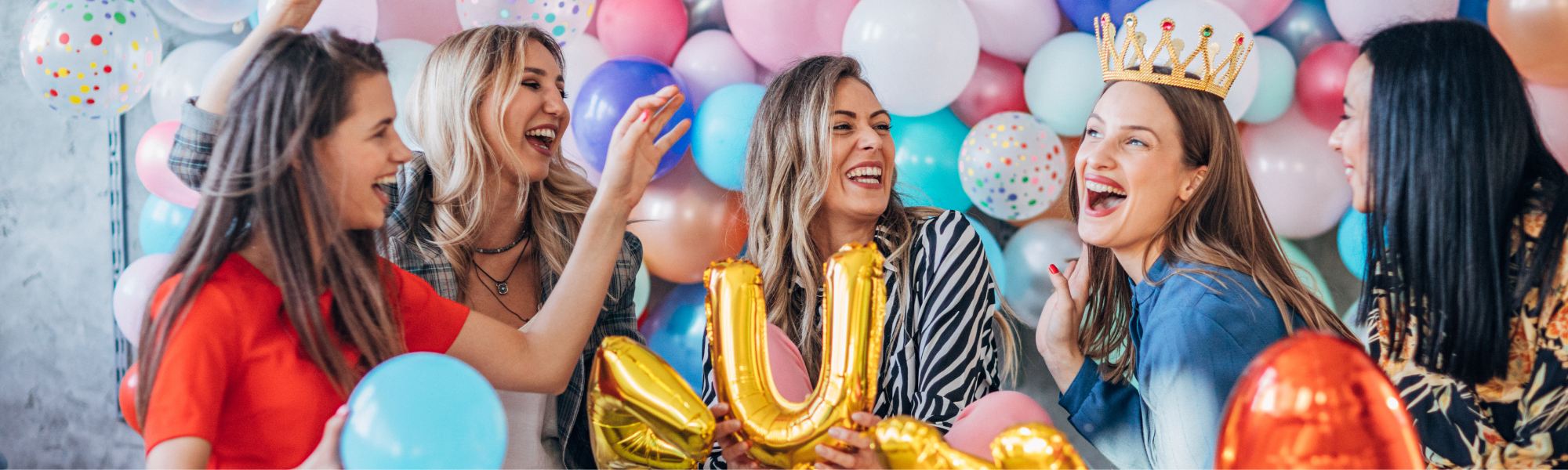 girls at a birthday party with balloons everywhere 